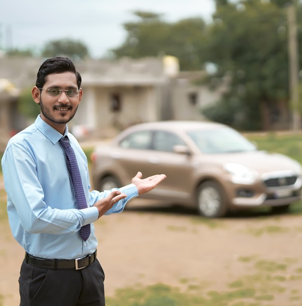Young indian banker or financier standing with car